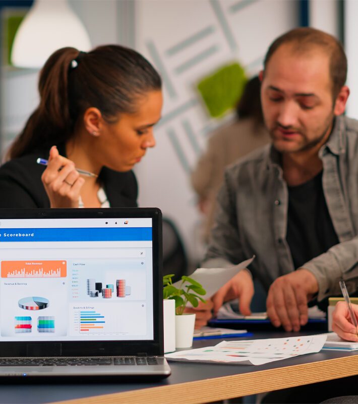 Business woman talking about financial project using laptop